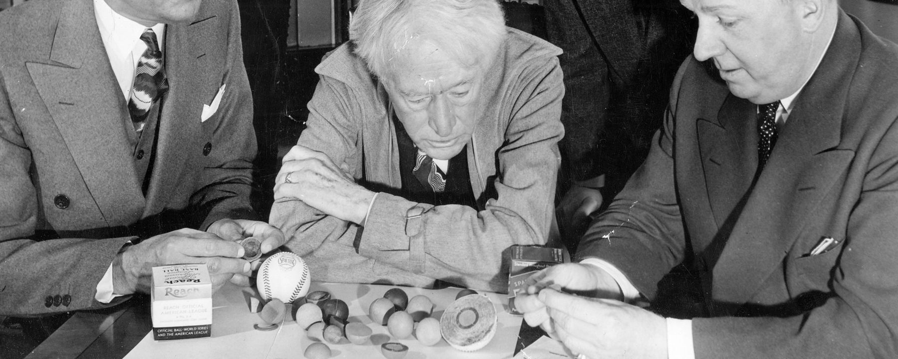 Examining vintage baseballs